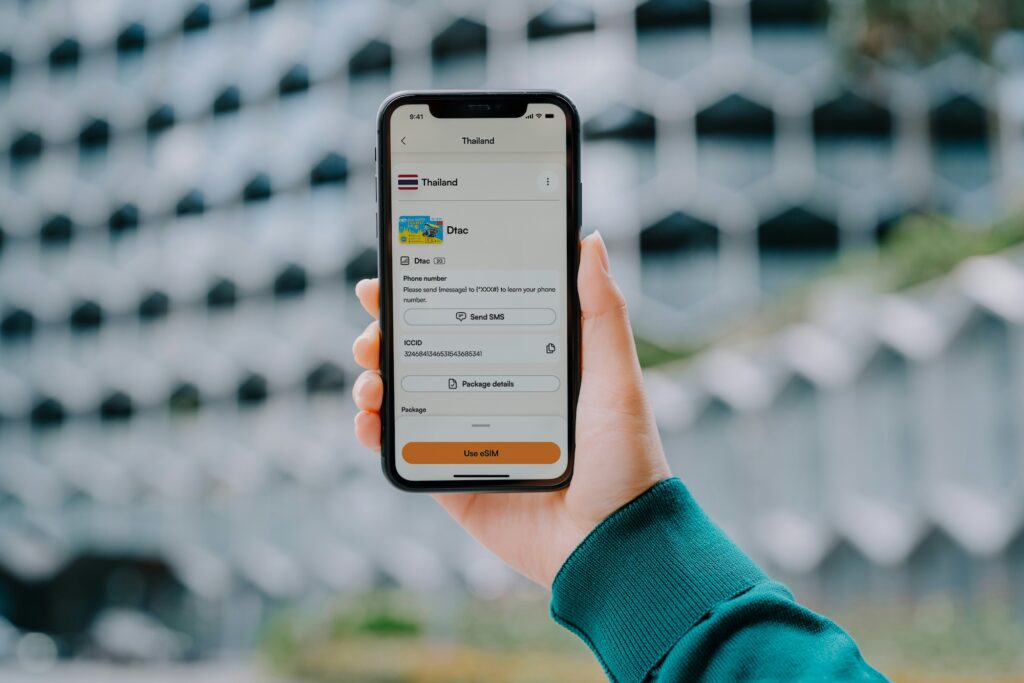 Hand holding a smartphone displaying a Thailand eSIM package in the Airalo app